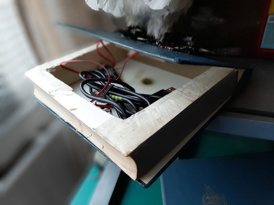 Used a hollow book to hide the battery power bank for the robot owl